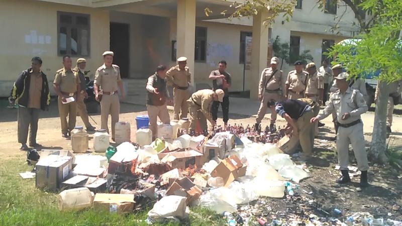 Seized Liquor displayed; some destroyed and burnt; many distributed among policemen