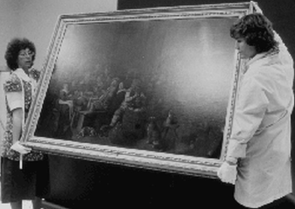 Figure 1. Medium-sized paintings should be handled by two persons, each with one hand holding the lower edge or bottom comer and the other hand placed along one side towards the top corner to balance the weight of the painting.