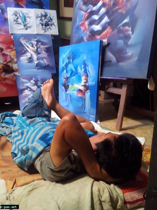 Painter Gandumpu gazes on his work thinking creative ways of enhancing his works.