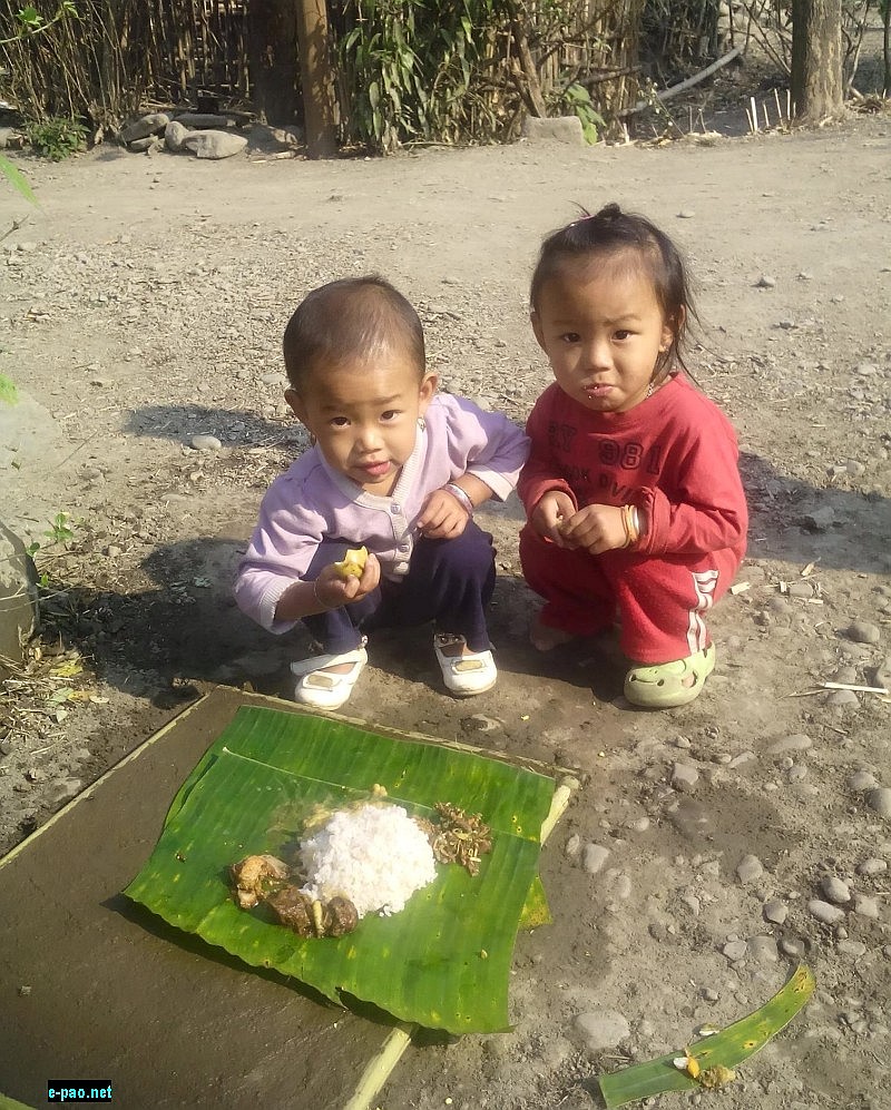  Two children enjoying Cheiraoba konthong chak at Awang Sekmai. Traditionally it include Pork, Local Chicken, Boiled Pumpkin and Singju 