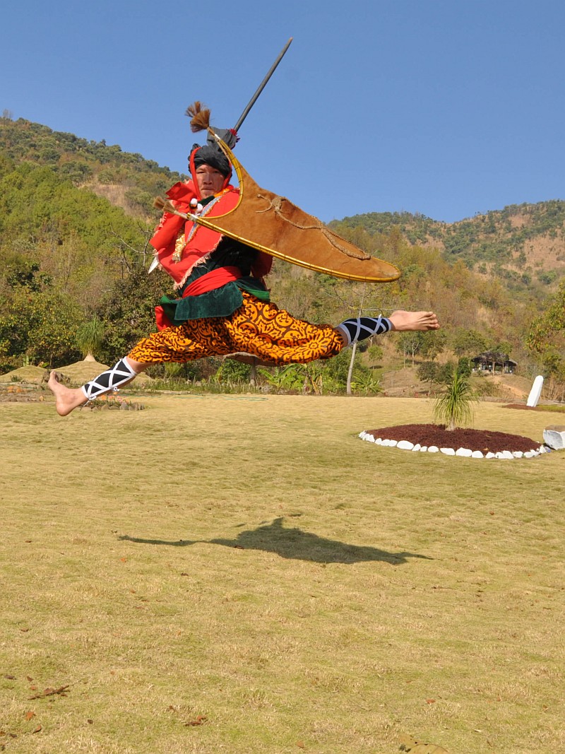 Rajen Mangang showing his skills in traditional war costume with sword and shield