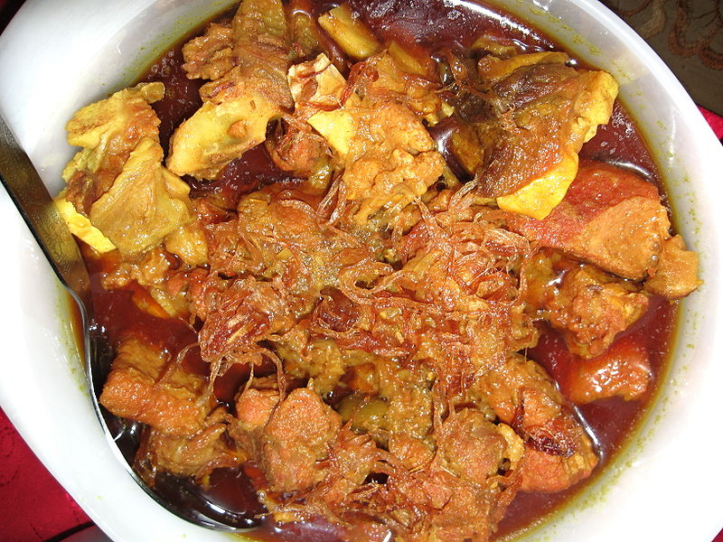 Beef curry in Bangladesh, served with roasted onion