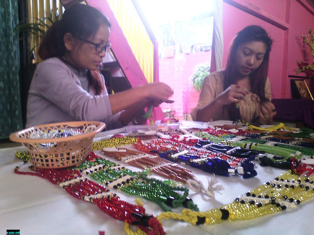 Limpuiru (Left) and her youngest sister working to have the handicrafts to sale at Sangai festival