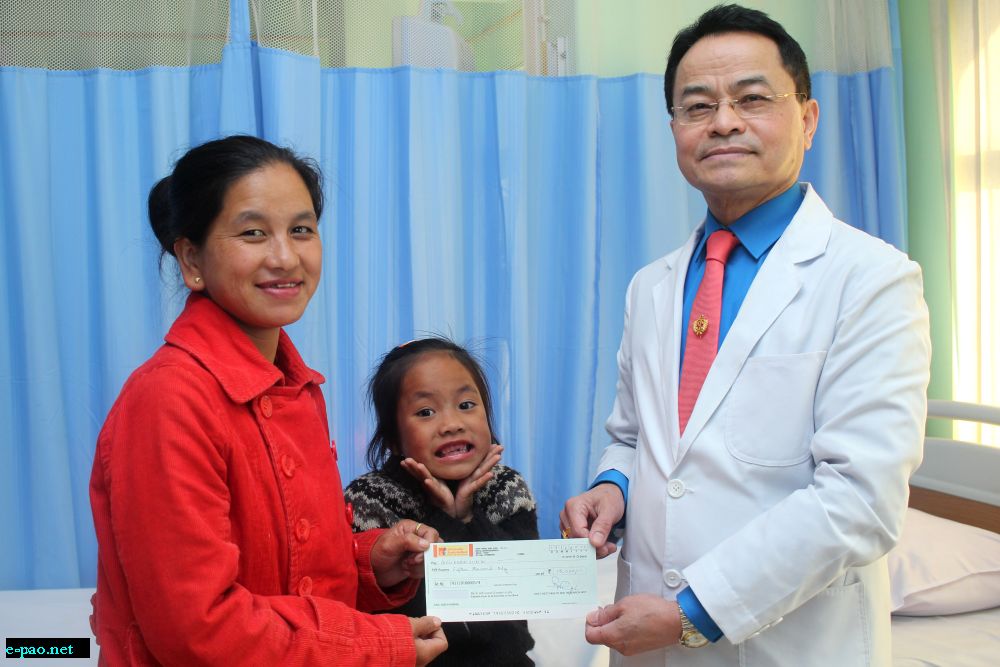 Dr L. Shyamkishore, President of Manipur Heart Foundation donating a cheque of Rupees Fifteen Thousand to a heart Patient from Ccpur District 