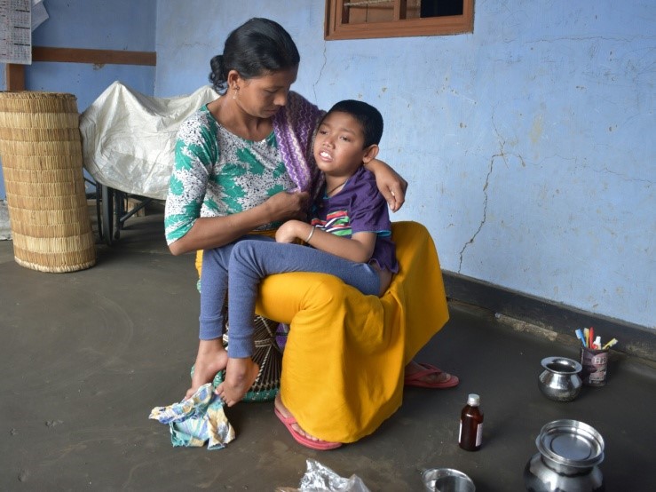 Sanamatum in his mother's lap 