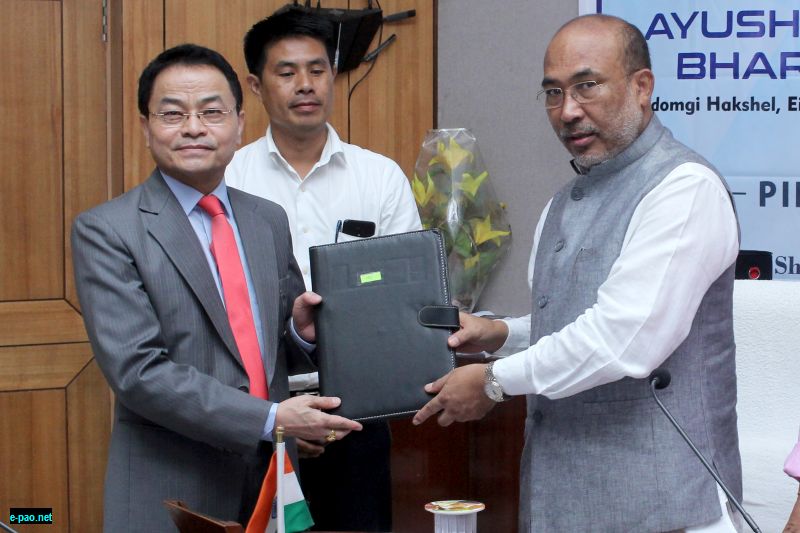  Shri N.Biren Singh - Chief Minister of Manipur handing over the MoU to Dr L.Shyamkishore Singh, Chairman and Chief Cardiologist of SKY Hospital, Imphal West.