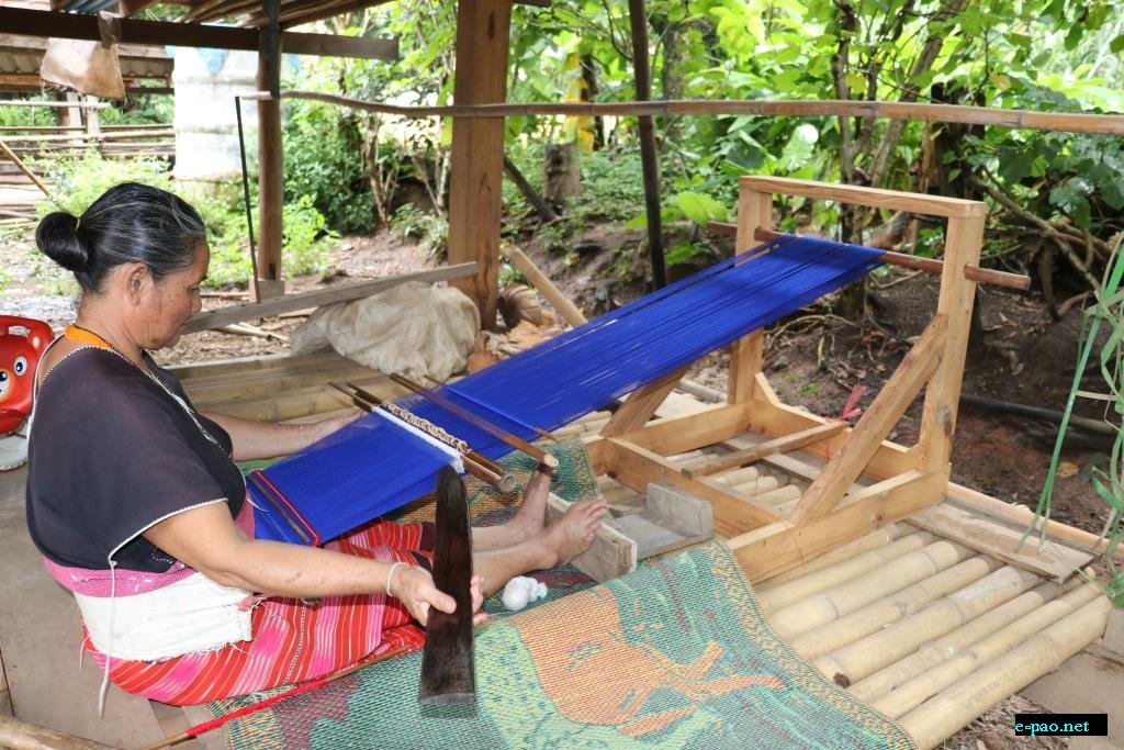  A Karen woman weaving traditional clothes  