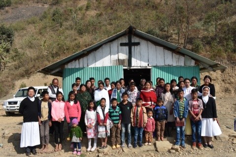   Villagers in front of the Catholic Church 