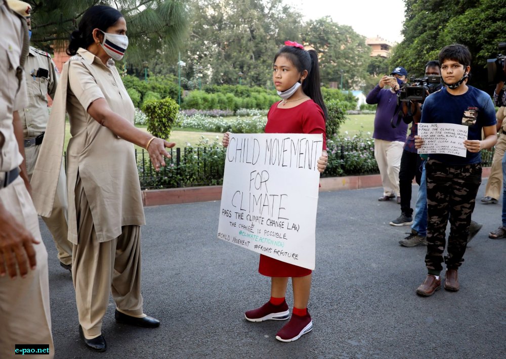  Police tries to stop Licypriya Kangujam  - Climate Activist holds a placard during a protest outside Parliament House to pass the Climate change law in the ongoing parliament session in New Delhi on September 23rd, 2020 