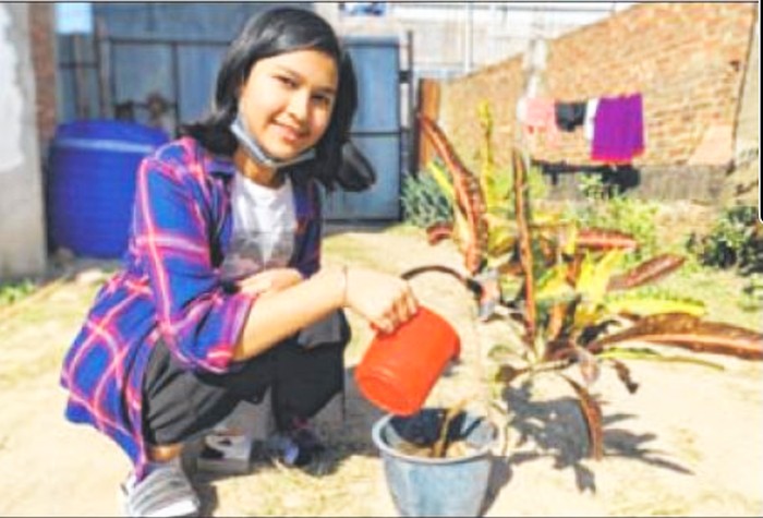  Bretina Rajkumari watering a plant 