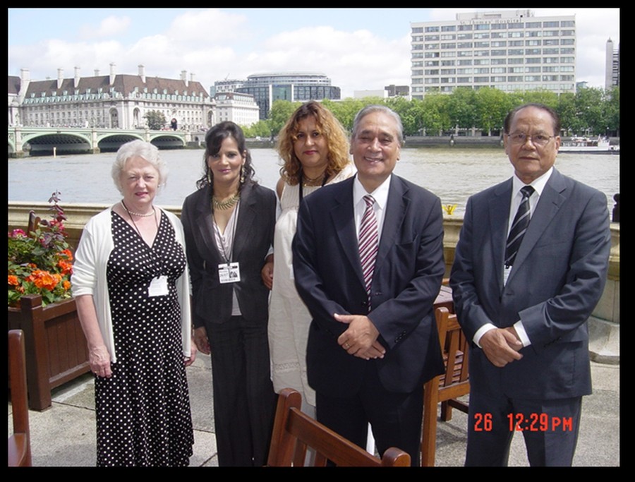  Author and Margaret with our MP Marsha Singh at the Terrace Bar of Parliament Building on the north bank of the River Thames, opposite St Thomas' Hospital [tall building on the right] on the south bank of the River, connected by Westminster Bridge on the left 