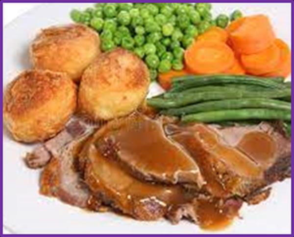  A typical English dinner with roast lamb with gravy, roast potatoes, boiled carrots and boiled peas.