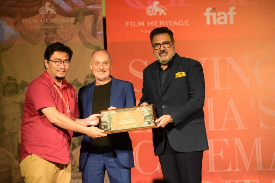  Johnson Rajkumar receiving the award from David Walsh, the FIAF Training and Outreach Coordinator and Boman Irani, acclaimed Indian actor  