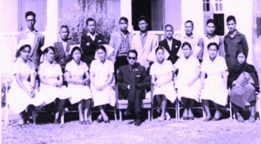  Staff of Churachandpur District Hospital (30 beds) in January 1966. Author (centre seated). On his (R) Staff Nurse Chingnu. On his (L) Staff Nurse Manu and other perfect and efficient nurses.
 