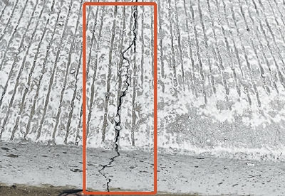Cracks begin to adorn rigid pavement